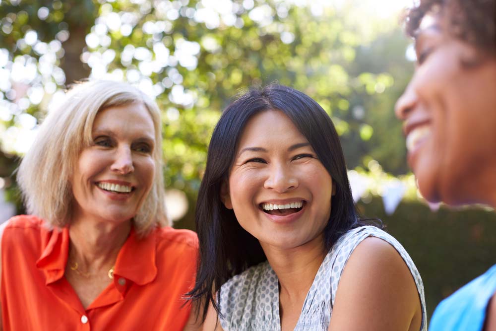 Smiling patient enjoying healthy smile at Griffith Dental after Implant Restorations