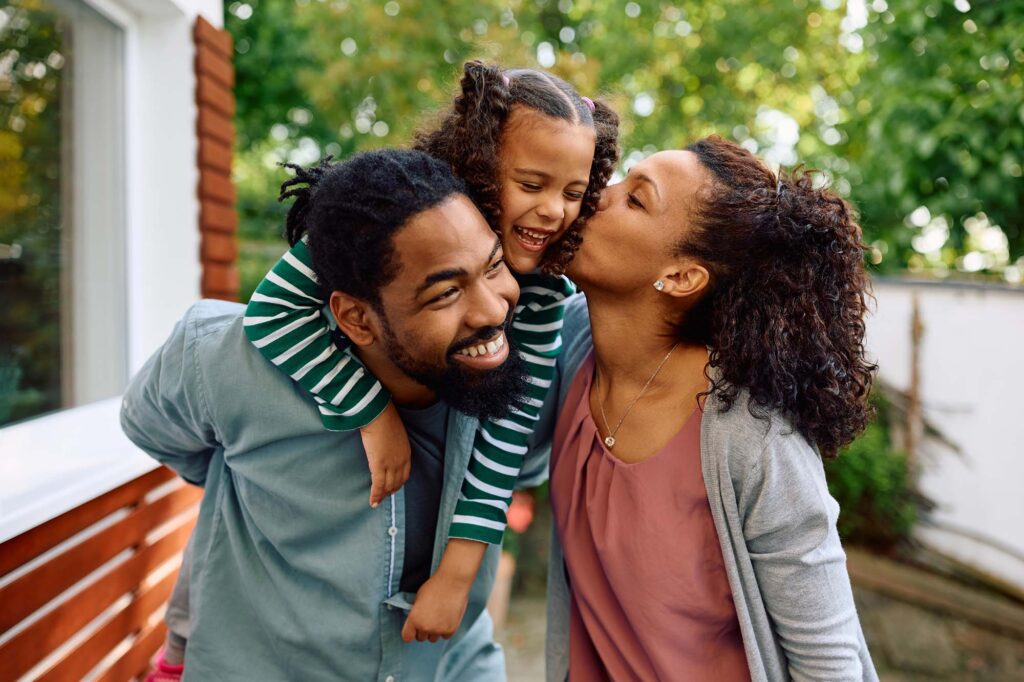 Happy family enjoying healthy smiles after dental treatment at Griffith Dental